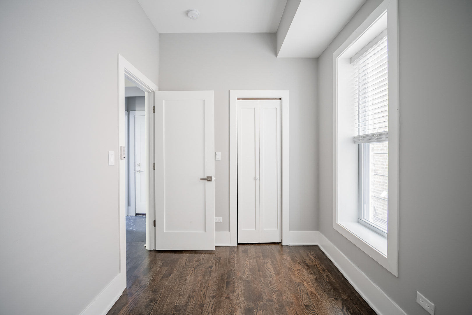 1472 West Erie Street, Unit 2F Chicago, IL 60642 - Photo 13 of 25 a view of an empty room with wooden floor and a window
