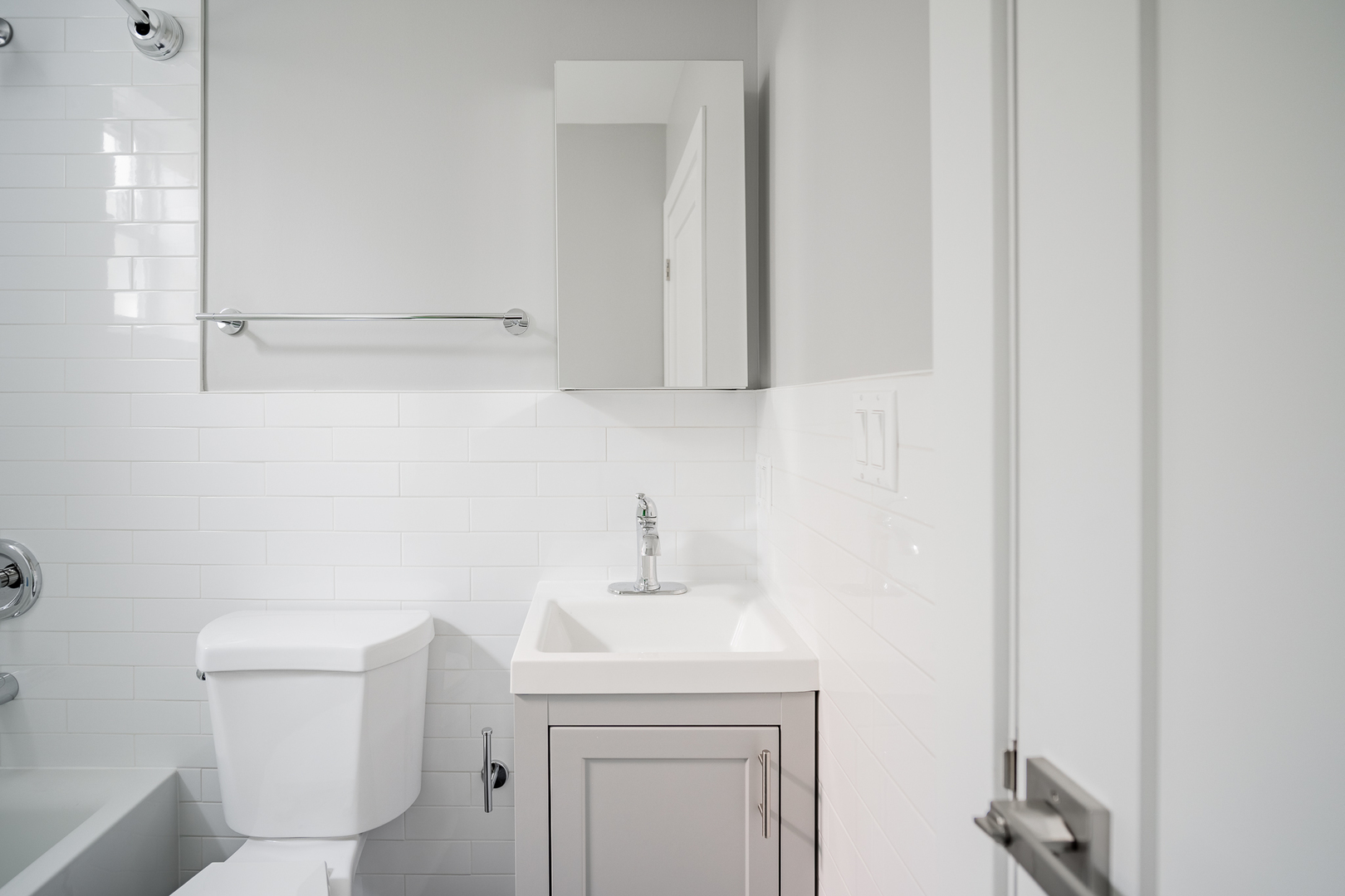 1472 West Erie Street, Unit 2F Chicago, IL 60642 - Photo 16 of 25 a bathroom with a sink a toilet and a mirror