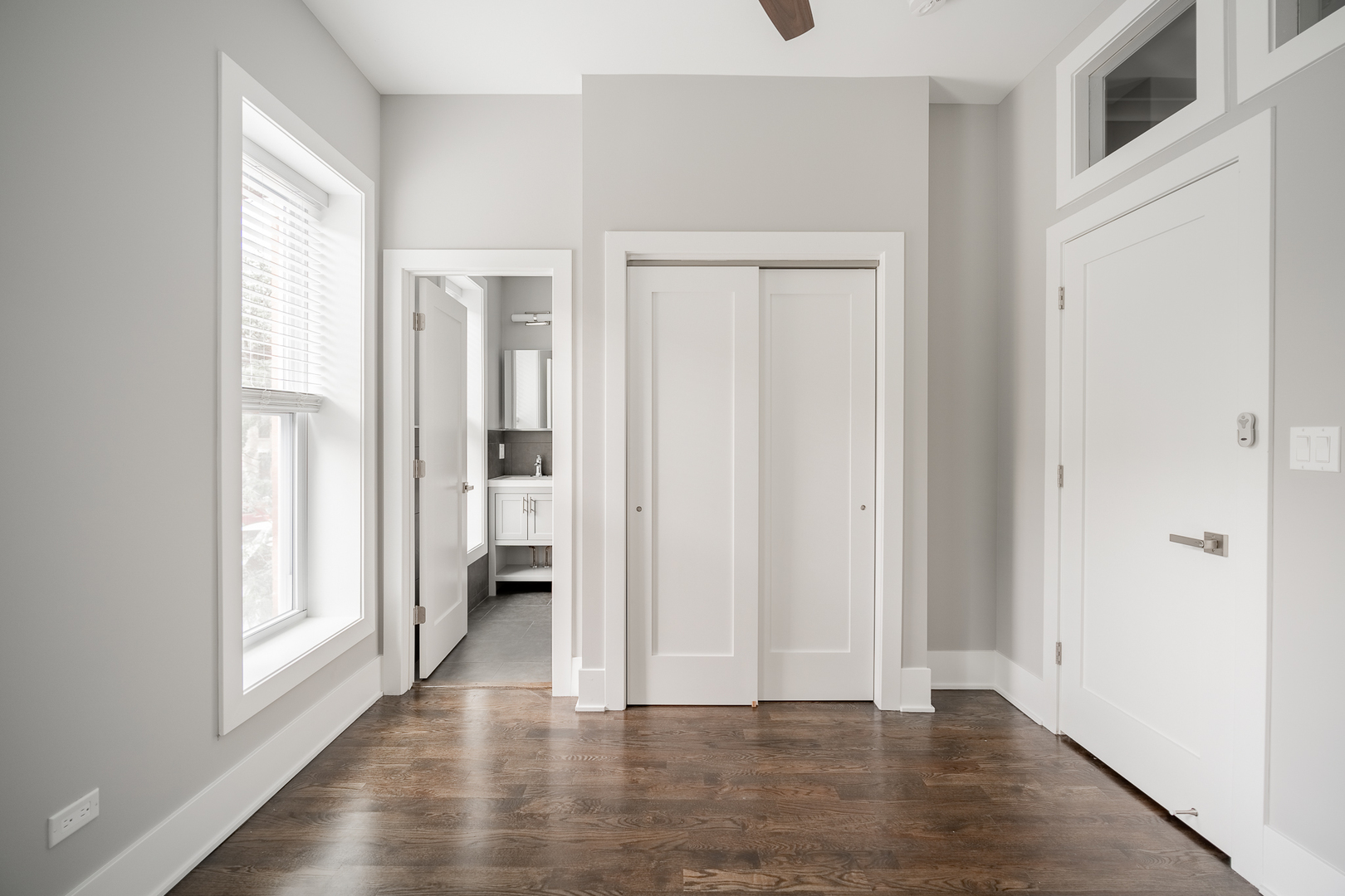 1472 West Erie Street, Unit 2F Chicago, IL 60642 - Photo 18 of 25 an empty room with wooden floor and windows
