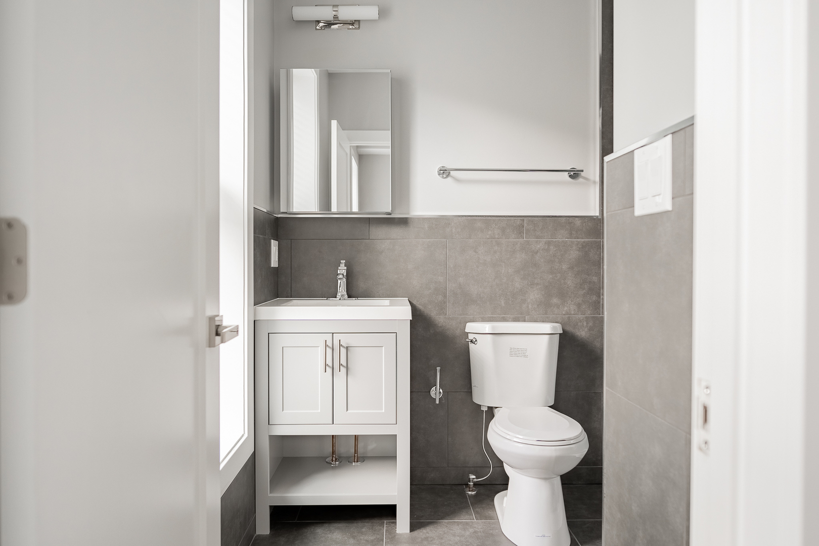 1472 West Erie Street, Unit 2F Chicago, IL 60642 - Photo 20 of 25 a bathroom with a toilet sink and mirror
