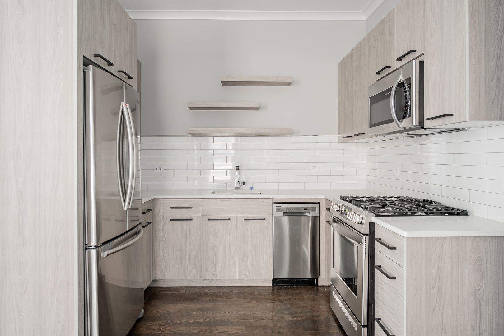 1472 West Erie Street, Unit 2F Chicago, IL 60642 - Photo 2 of 25 a kitchen with stainless steel appliances granite countertop a sink stove and refrigerator
