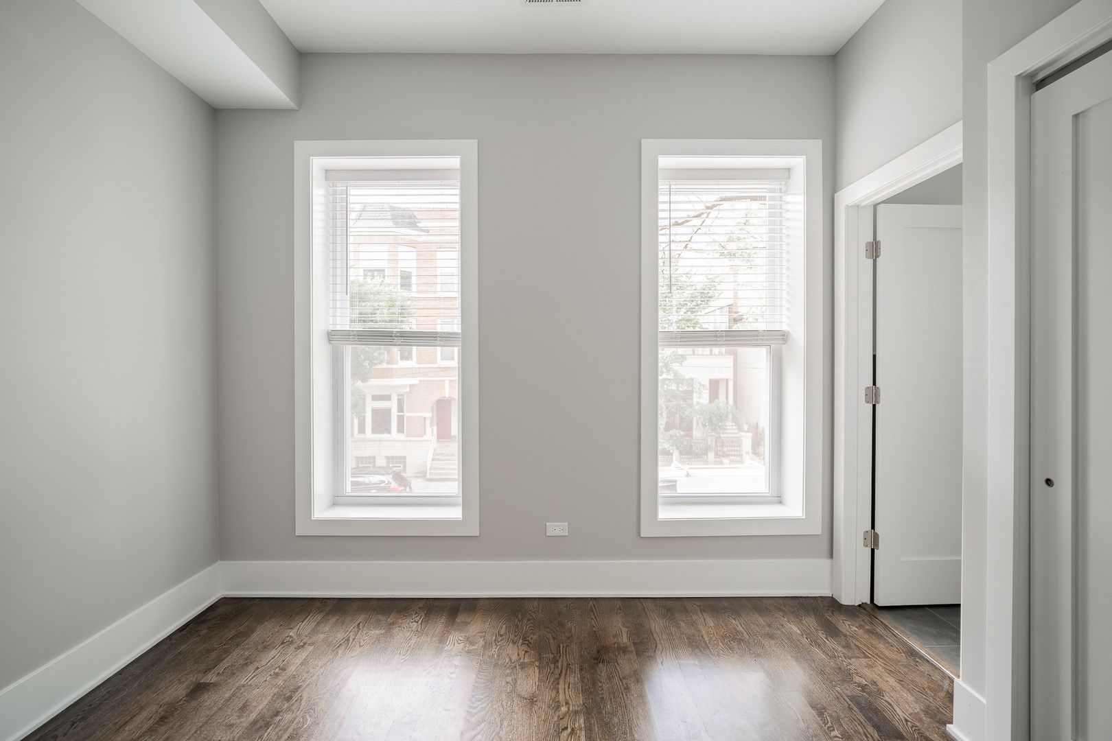1472 West Erie Street, Unit 2F Chicago, IL 60642 - Photo 23 of 25 a view of an empty room with wooden floor and a window