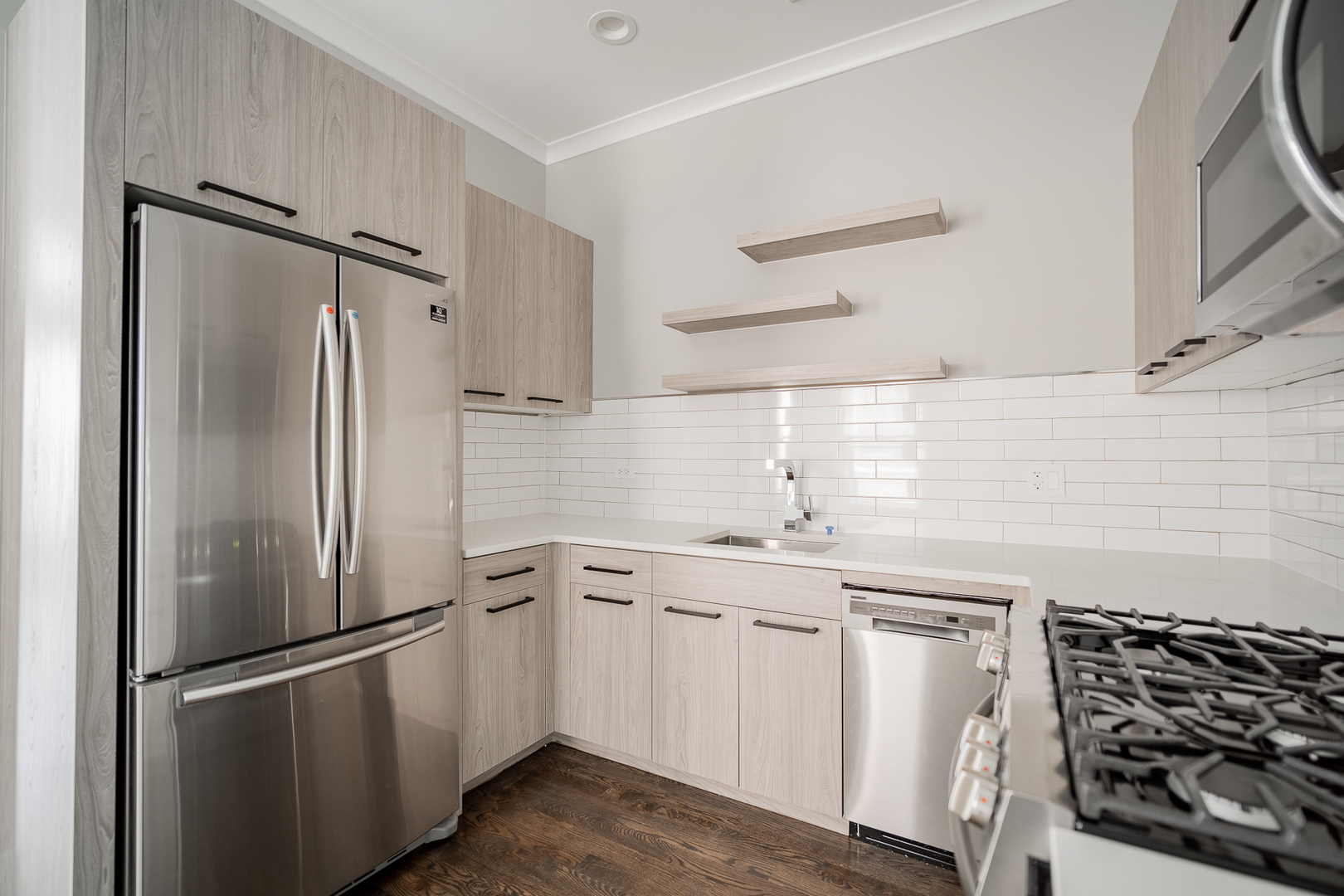 1472 West Erie Street, Unit 2F Chicago, IL 60642 - Photo 3 of 25 a kitchen with a refrigerator and a sink