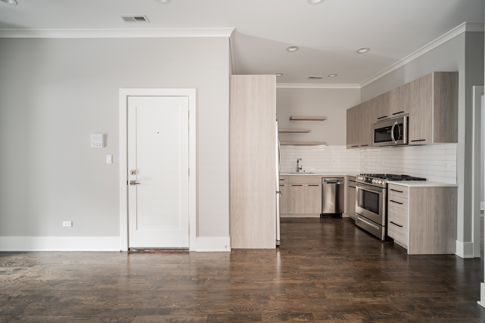 1472 West Erie Street, Unit 2F Chicago, IL 60642 - Photo 5 of 25 a kitchen with a refrigerator stove and a sink