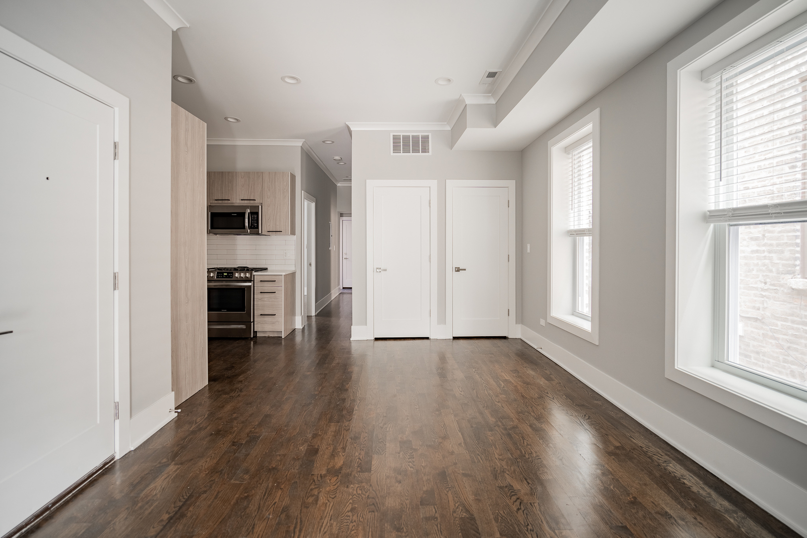 1472 West Erie Street, Unit 2F Chicago, IL 60642 - Photo 6 of 25 wooden floor in an empty room with a window