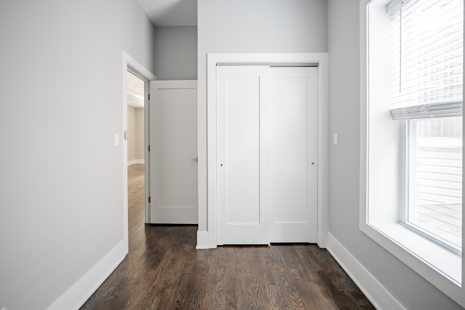 1472 West Erie Street, Unit 2F Chicago, IL 60642 - Photo 9 of 25 a view of an empty room with wooden floor and a window
