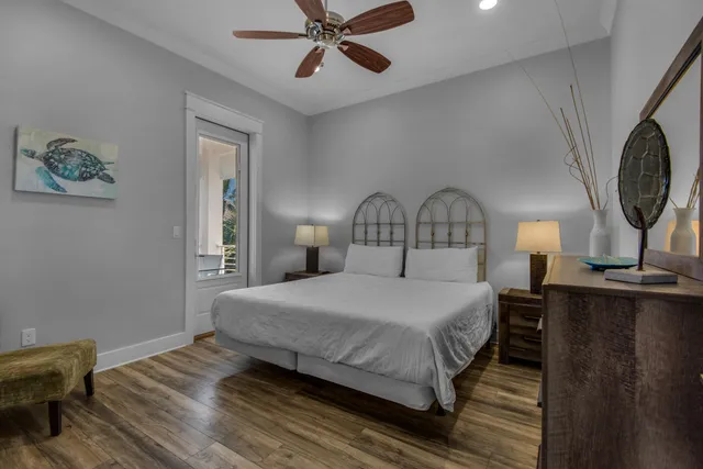 a bedroom with a bed a chandelier and dresser