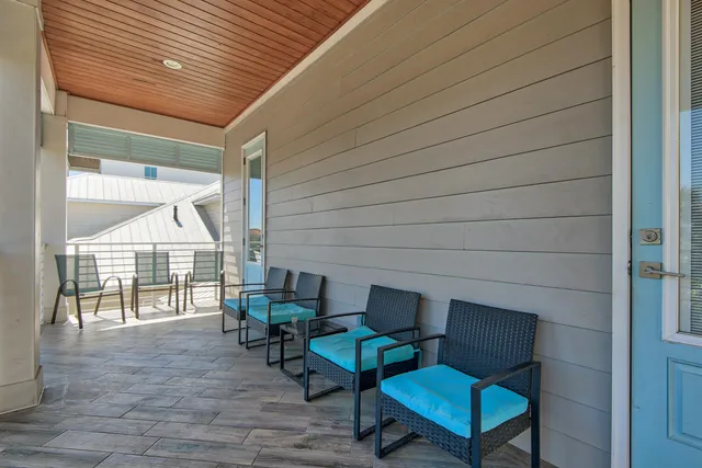 a balcony with furniture and a potted plant