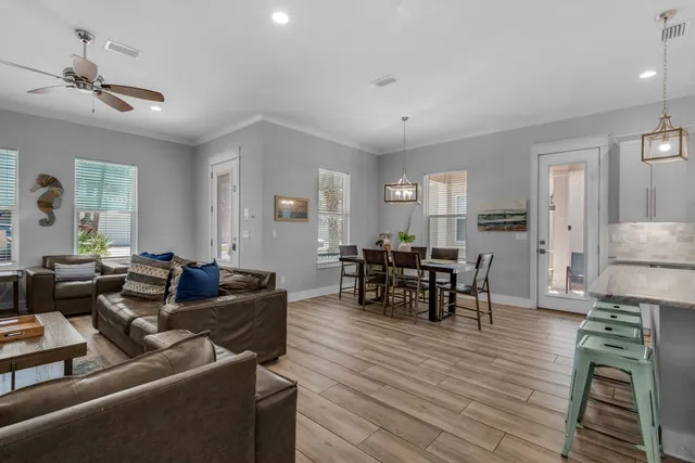 a living room with furniture and wooden floor