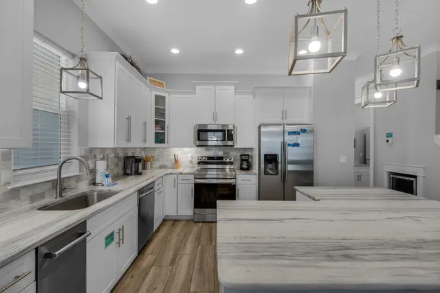 a kitchen with stainless steel appliances kitchen island granite countertop a sink and cabinets