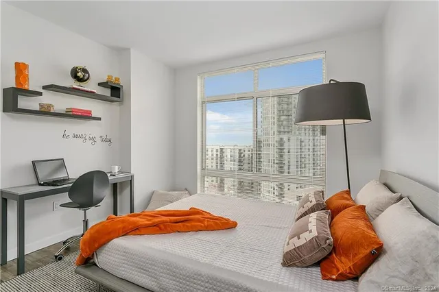 a bedroom with a bed and a chair