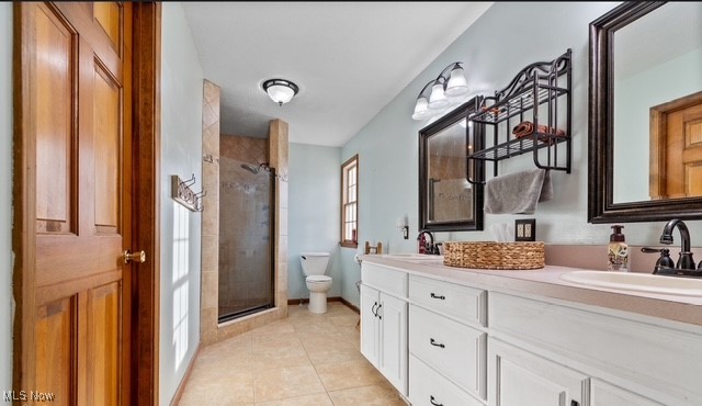 8995 Ridge Road Wooster, OH 44691 - Photo 28 of 50 Bathroom with a stall shower, double vanity, and light tile patterned floors