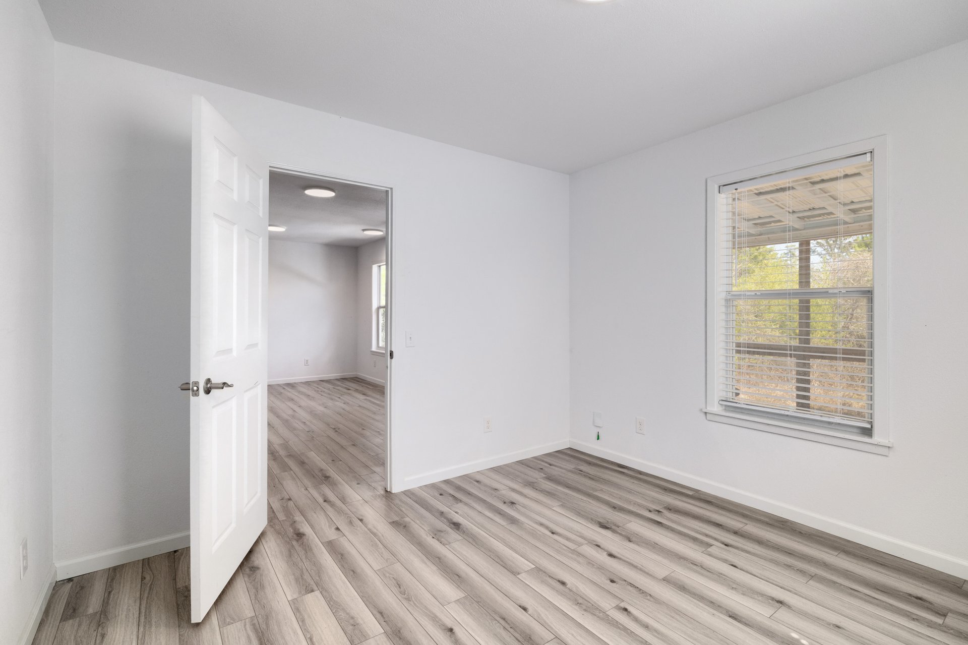 270 Kelley Road West Bastrop, TX 78602 - Photo 10 of 29 an empty room with wooden floor and windows