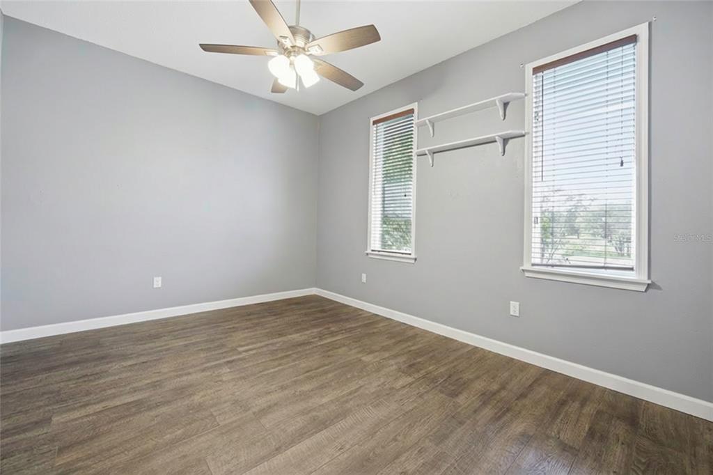 10400 Southeast 101st Avenue Road Belleview, FL 34420 - Photo 12 of 59 a view of an empty room with wooden floor and a window