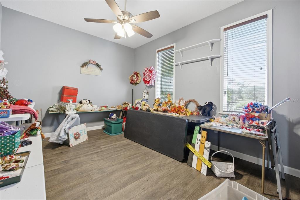 10400 Southeast 101st Avenue Road Belleview, FL 34420 - Photo 13 of 59 a room with furniture a chandelier and a window