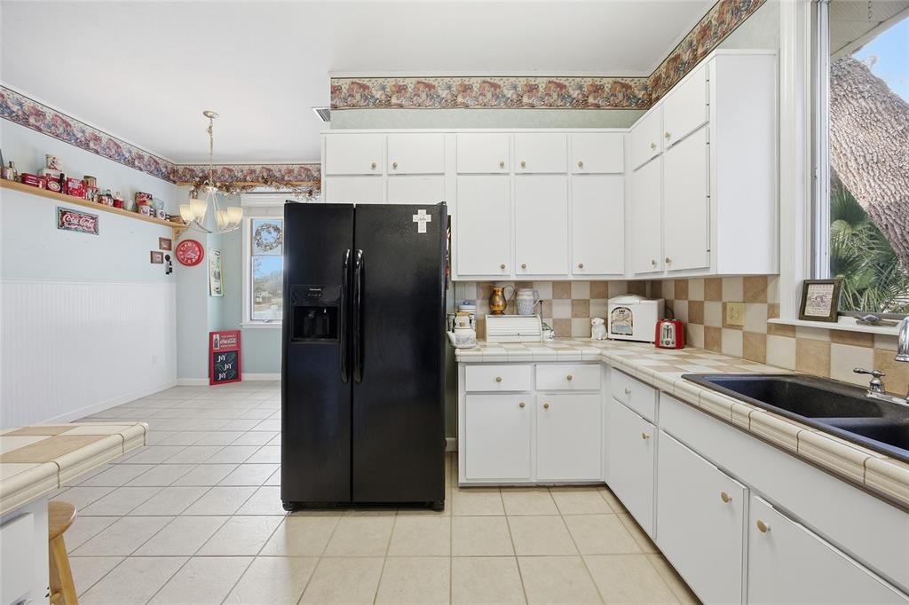 10400 Southeast 101st Avenue Road Belleview, FL 34420 - Photo 19 of 59 a kitchen with a refrigerator and cabinets