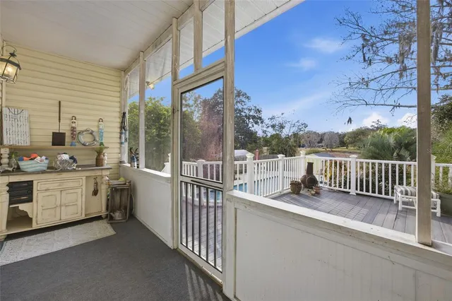 a view of a yard in front of a house with a large tree