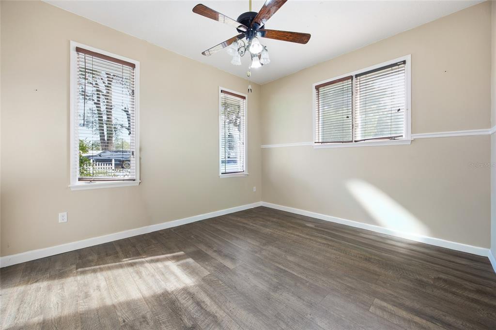 10400 Southeast 101st Avenue Road Belleview, FL 34420 - Photo 10 of 59 a view of an empty room with window and wooden floor