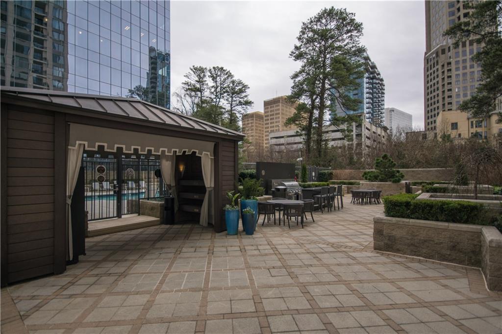 3445 Stratford Road Northeast, Unit 2107 Atlanta, GA 30326 - Photo 16 of 22 a view of outdoor space with seating area and covered with trees