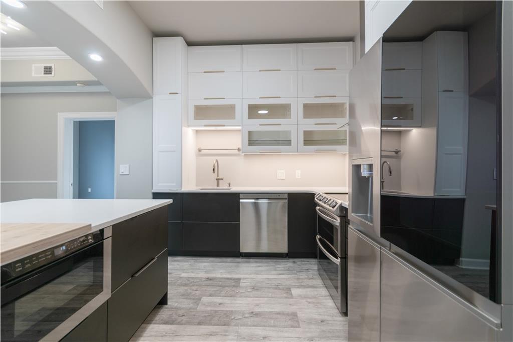 3445 Stratford Road Northeast, Unit 2107 Atlanta, GA 30326 - Photo 3 of 22 a kitchen with stainless steel appliances granite countertop a refrigerator and a stove top oven