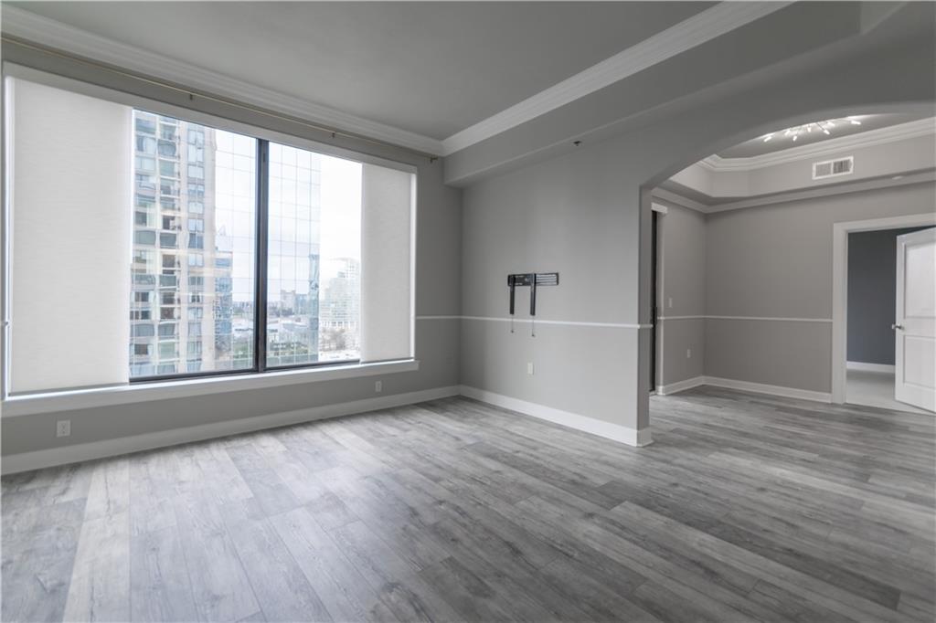 3445 Stratford Road Northeast, Unit 2107 Atlanta, GA 30326 - Photo 5 of 22 wooden floor in an empty room with a window