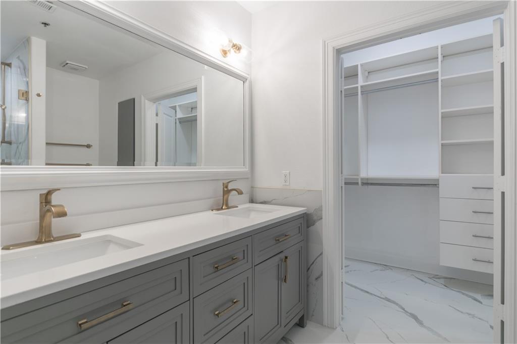 3445 Stratford Road Northeast, Unit 2107 Atlanta, GA 30326 - Photo 8 of 22 a bathroom with a sink and a mirror