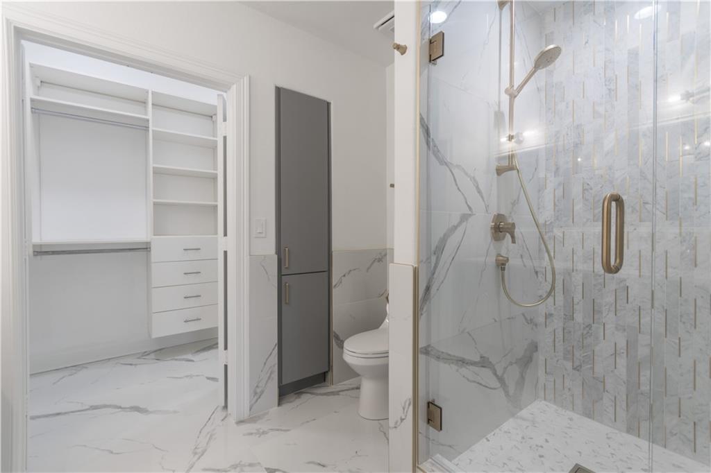 3445 Stratford Road Northeast, Unit 2107 Atlanta, GA 30326 - Photo 9 of 22 a bathroom with a shower and a toilet