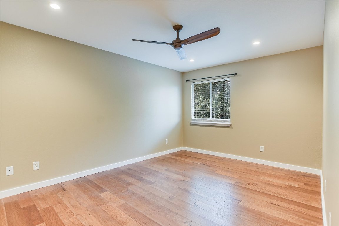 3231 Foothills Trail Round Rock, TX 78681 - Photo 11 of 25 Second bedroom featuring engineered hardwood flooring, recessed lighting, and a modern ceiling fan.
Room is approximately 11 x 14 ft.