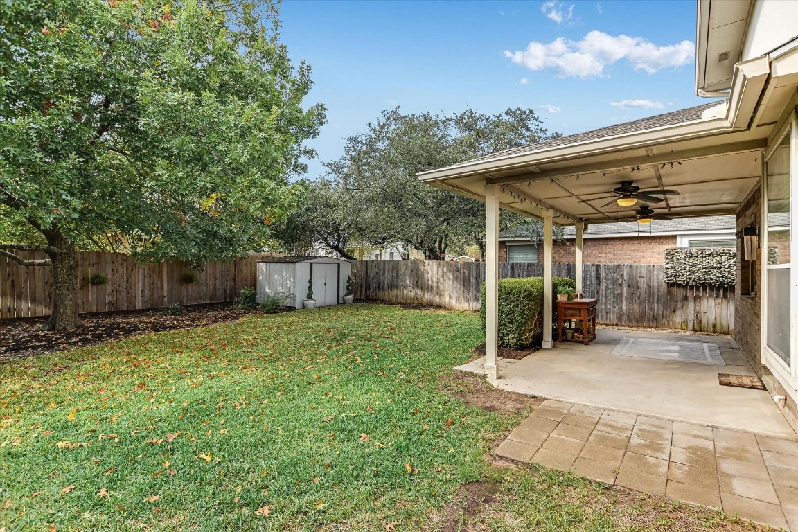3231 Foothills Trail Round Rock, TX 78681 - Photo 17 of 25 Covered Patio with lights, and ceiling fan. Fenced backyard, with 2 storage sheds