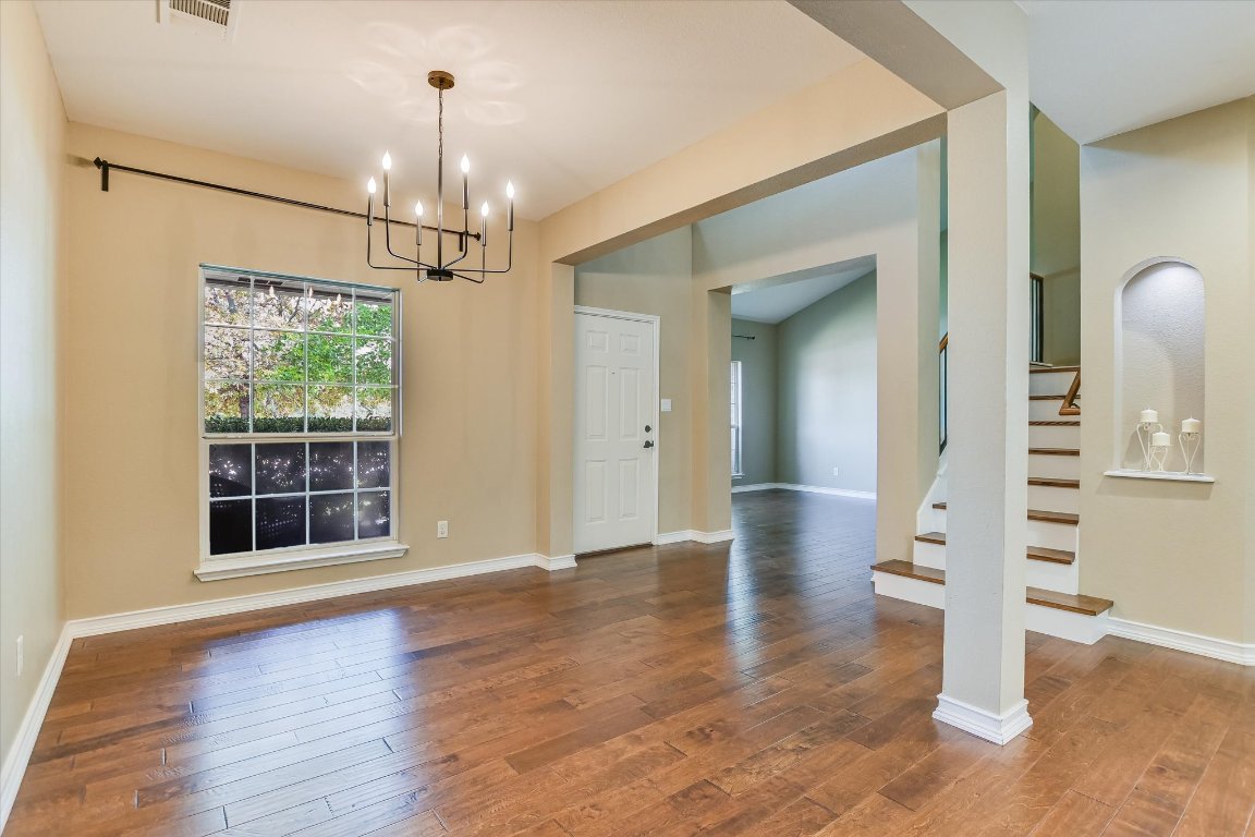 3231 Foothills Trail Round Rock, TX 78681 - Photo 2 of 25 Dining area has large open space.The large front window provides great light. Room is large enough to handle any size table. The modern chandelier is the focal point of the room.