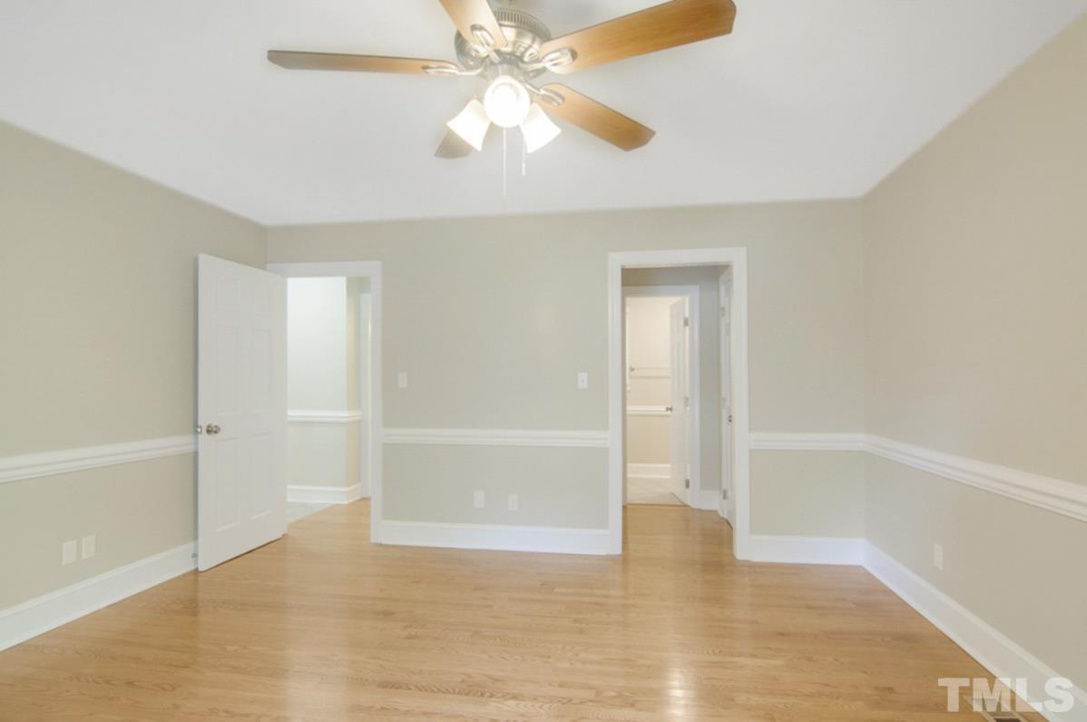 500 Chapwith Road Garner, NC 27529 - Photo 13 of 28 a view of an empty room with wooden floor and a ceiling fan