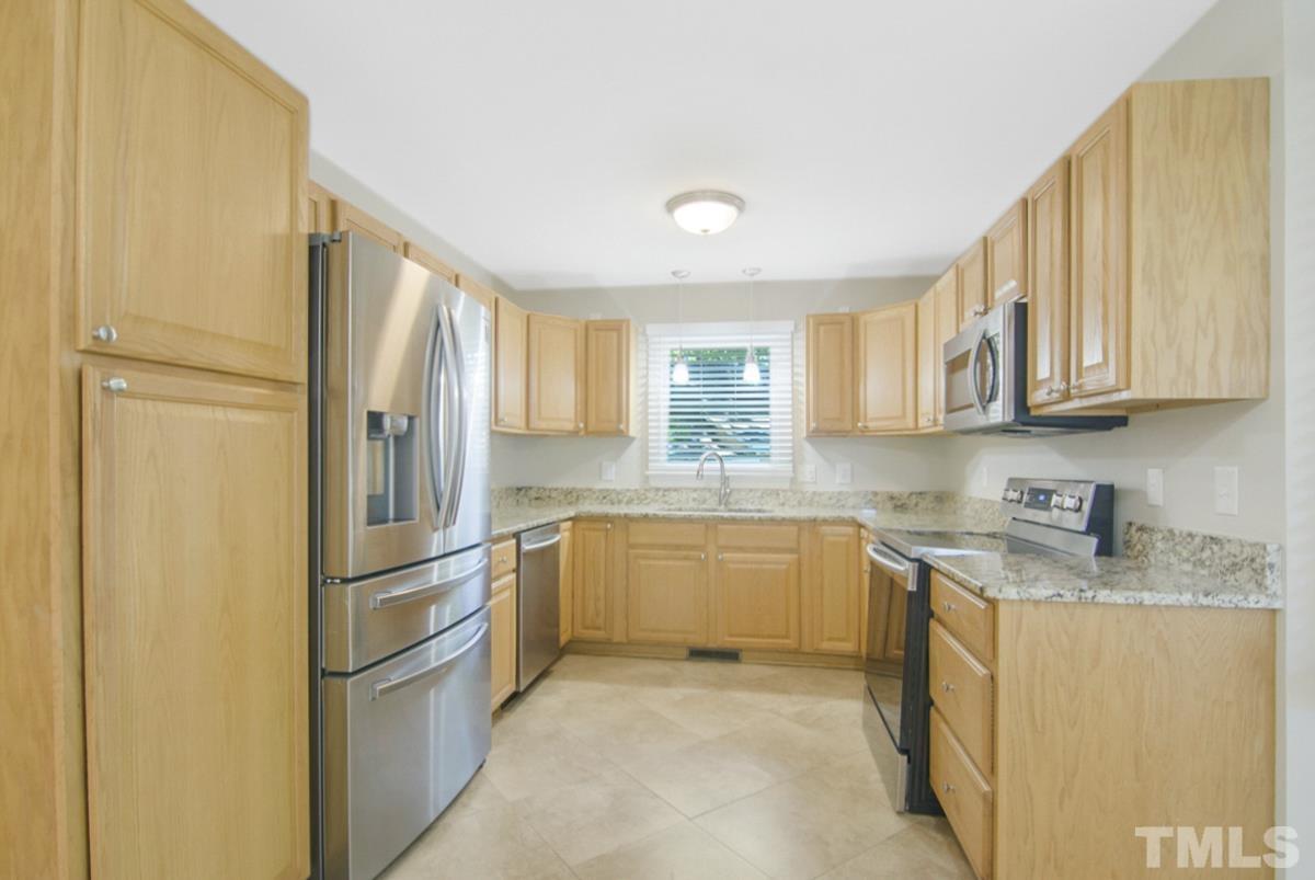 500 Chapwith Road Garner, NC 27529 - Photo 6 of 28 a kitchen with stainless steel appliances granite countertop a refrigerator and a stove top oven
