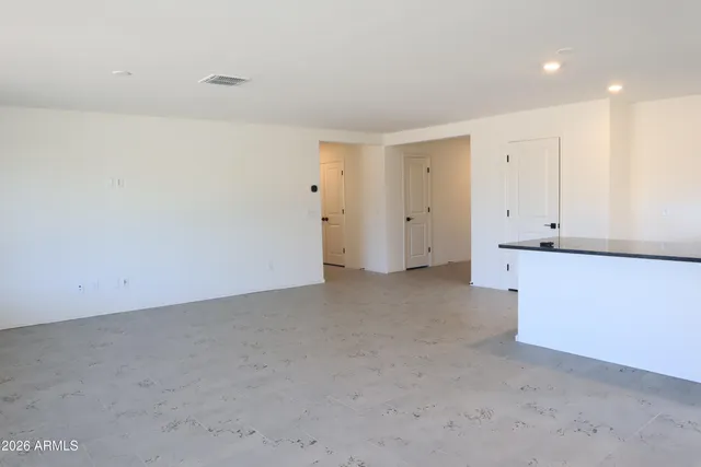 a view of a hallway with an entryway door