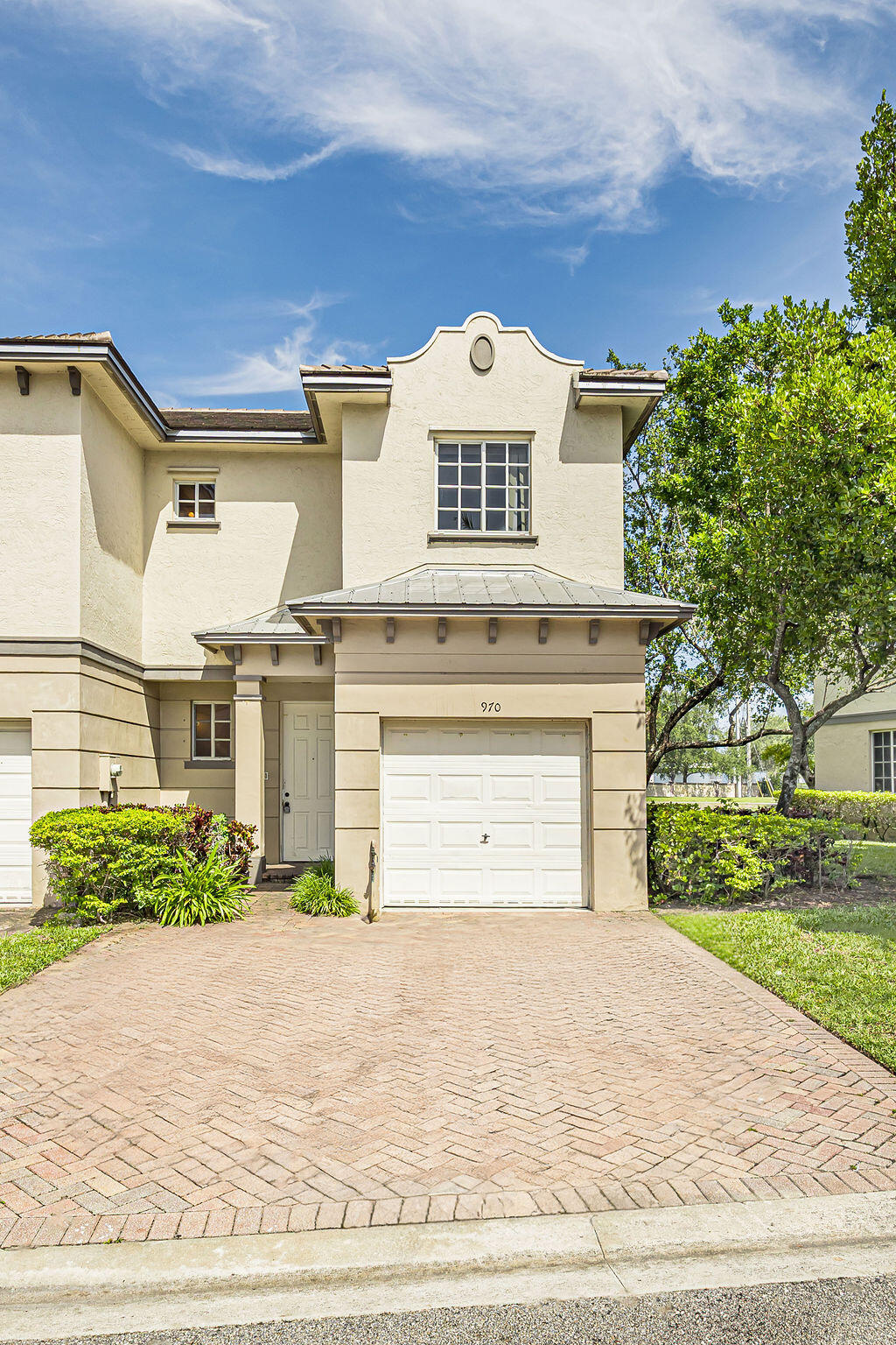 970 Tortuga Drive Riviera Beach, FL 33404 - Photo 1 of 37 a front view of a house with a yard and garage