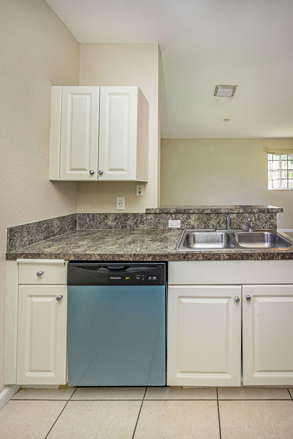 970 Tortuga Drive Riviera Beach, FL 33404 - Photo 15 of 37 a kitchen with granite countertop white cabinets and a stove
