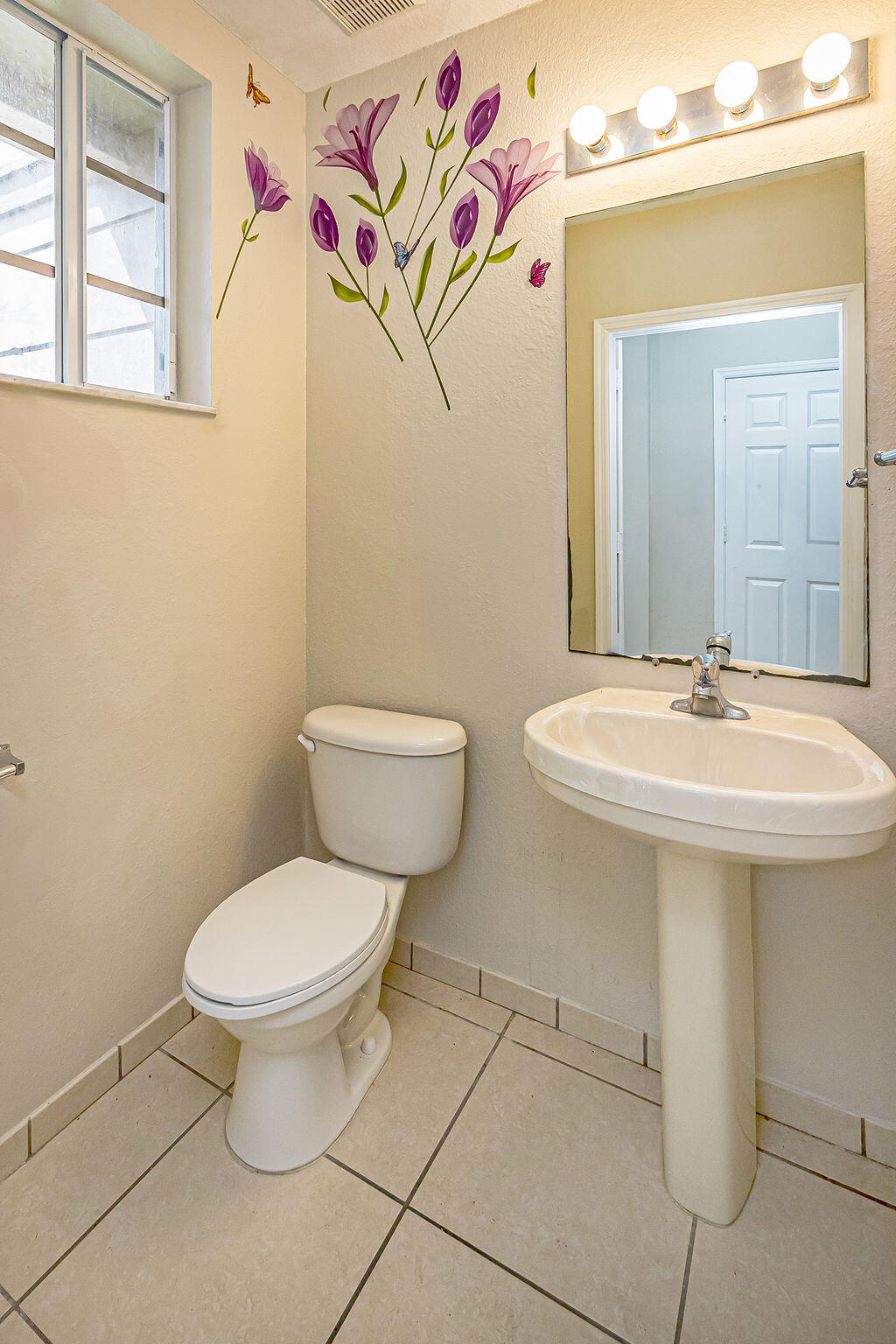 970 Tortuga Drive Riviera Beach, FL 33404 - Photo 16 of 37 a bathroom with a sink toilet and mirror