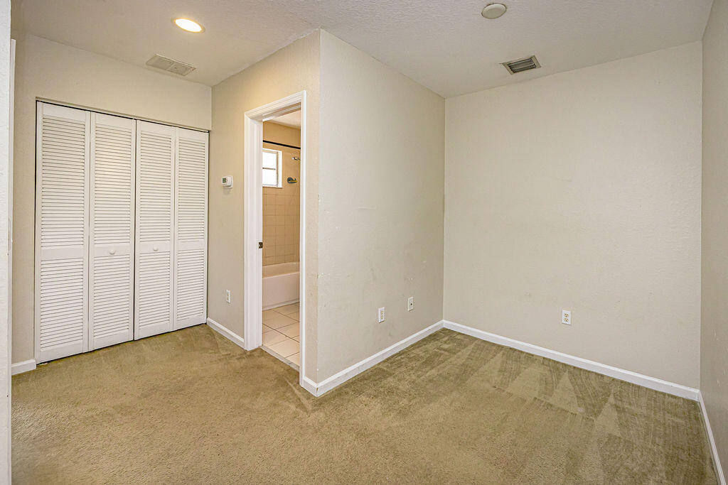 970 Tortuga Drive Riviera Beach, FL 33404 - Photo 18 of 37 an empty room with closet area
