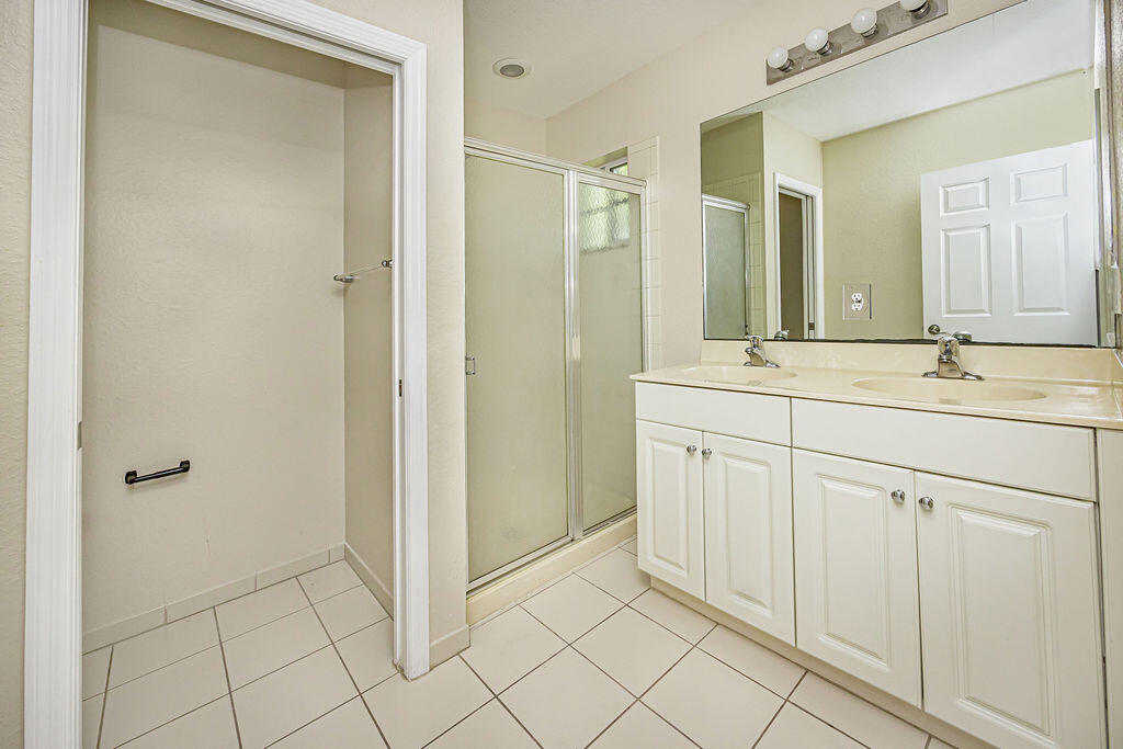 970 Tortuga Drive Riviera Beach, FL 33404 - Photo 24 of 37 a spacious bathroom with a mirror sink and vanity