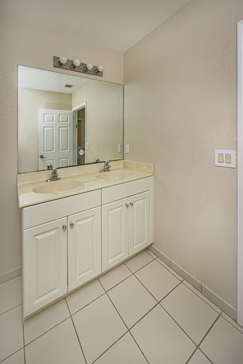 970 Tortuga Drive Riviera Beach, FL 33404 - Photo 25 of 37 a bathroom with a sink and a mirror