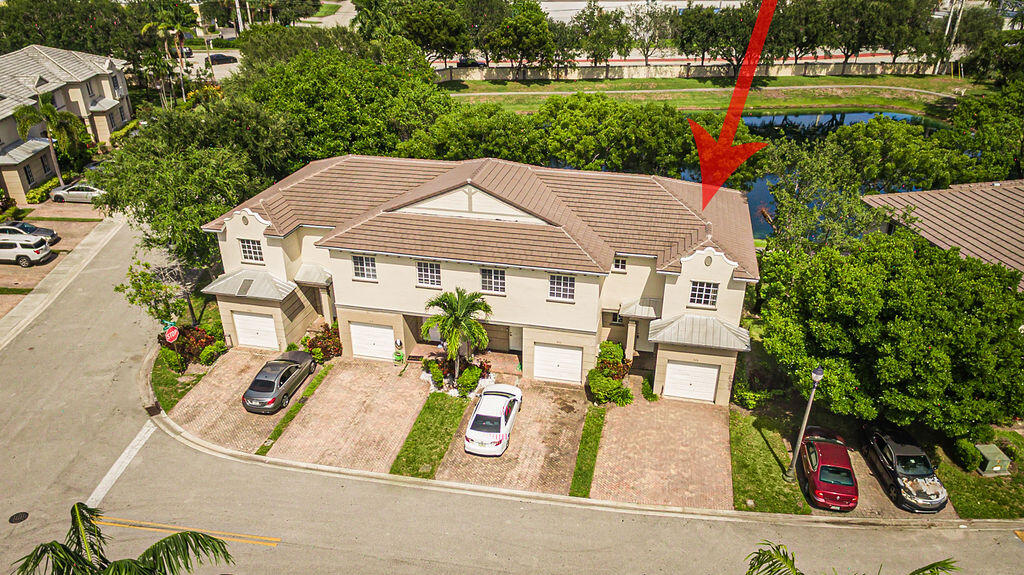 970 Tortuga Drive Riviera Beach, FL 33404 - Photo 34 of 37 an aerial view of a house with outdoor space patio and trees all around
