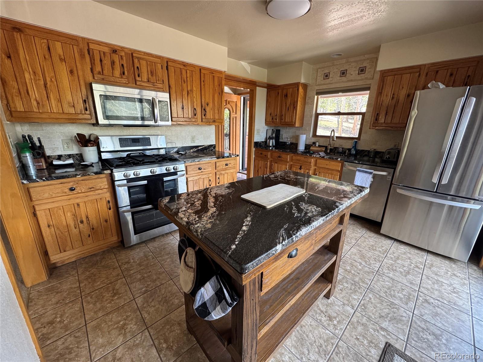 70 Highpoint Circle Black Hawk, CO 80422 - Photo 12 of 37 a kitchen with stainless steel appliances granite countertop a stove a sink dishwasher and a refrigerator