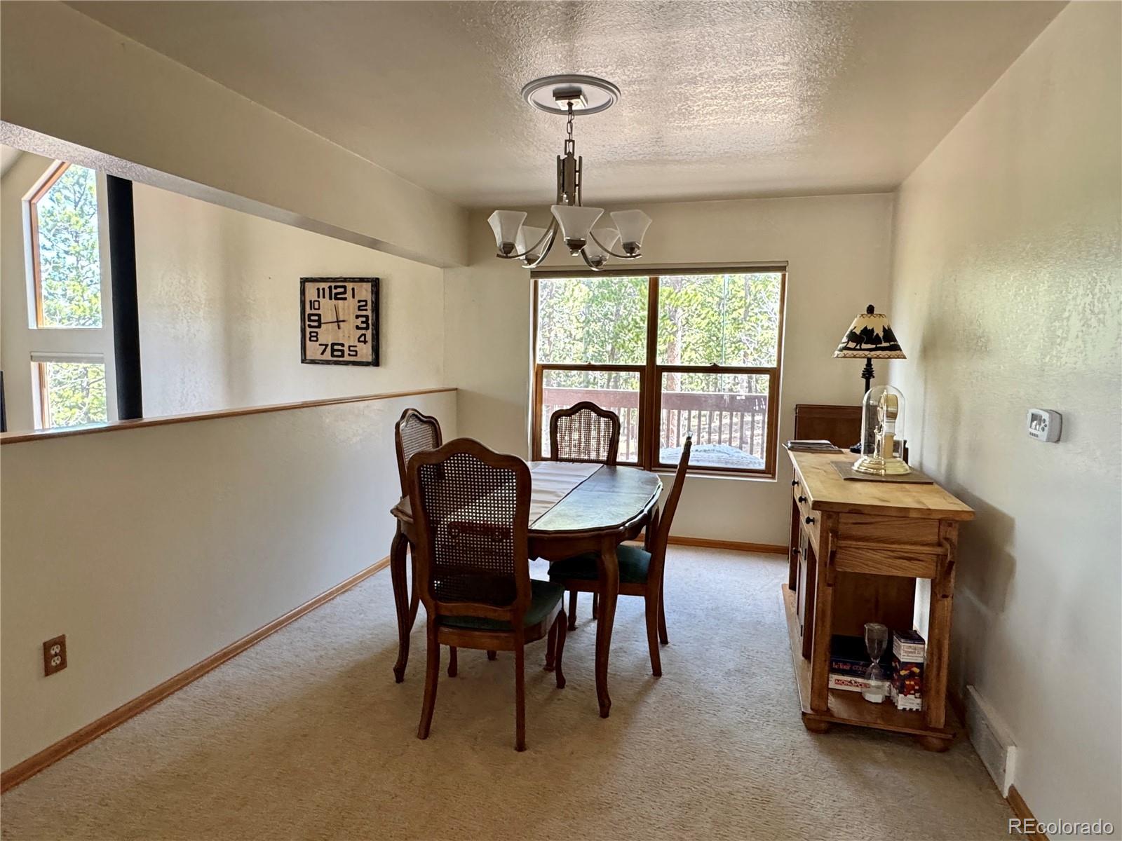 70 Highpoint Circle Black Hawk, CO 80422 - Photo 13 of 37 a view of a dining room with furniture window and outside view