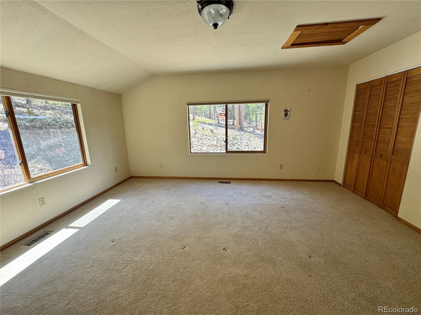 70 Highpoint Circle Black Hawk, CO 80422 - Photo 20 of 37 an empty room with windows and closet