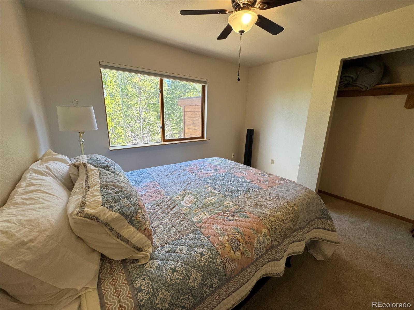 70 Highpoint Circle Black Hawk, CO 80422 - Photo 22 of 37 a bed sitting in a bedroom next to a window