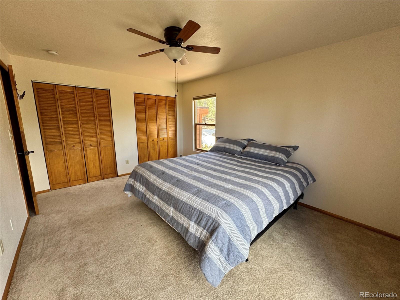 70 Highpoint Circle Black Hawk, CO 80422 - Photo 25 of 37 a large bed sitting in a bedroom next to a window