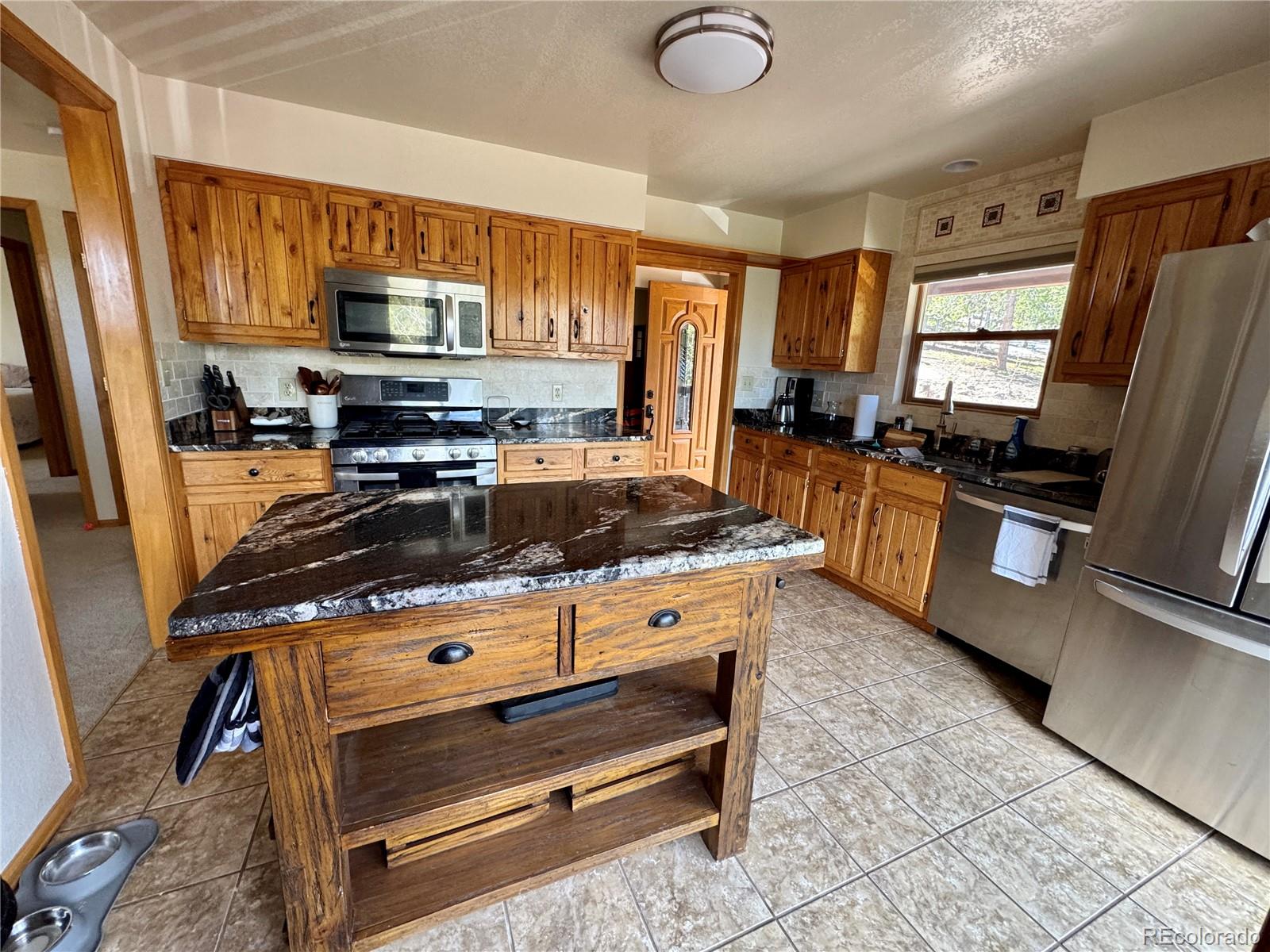 70 Highpoint Circle Black Hawk, CO 80422 - Photo 7 of 37 a kitchen with stainless steel appliances a stove a sink and a refrigerator