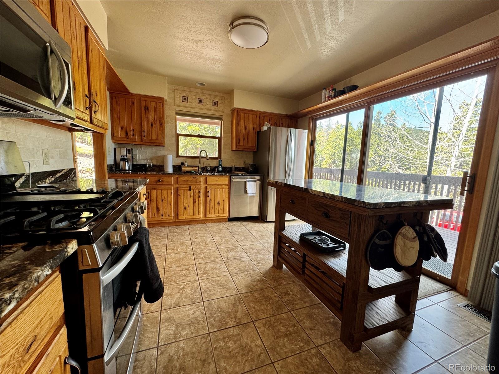 70 Highpoint Circle Black Hawk, CO 80422 - Photo 8 of 37 a kitchen with sink stove and cabinets