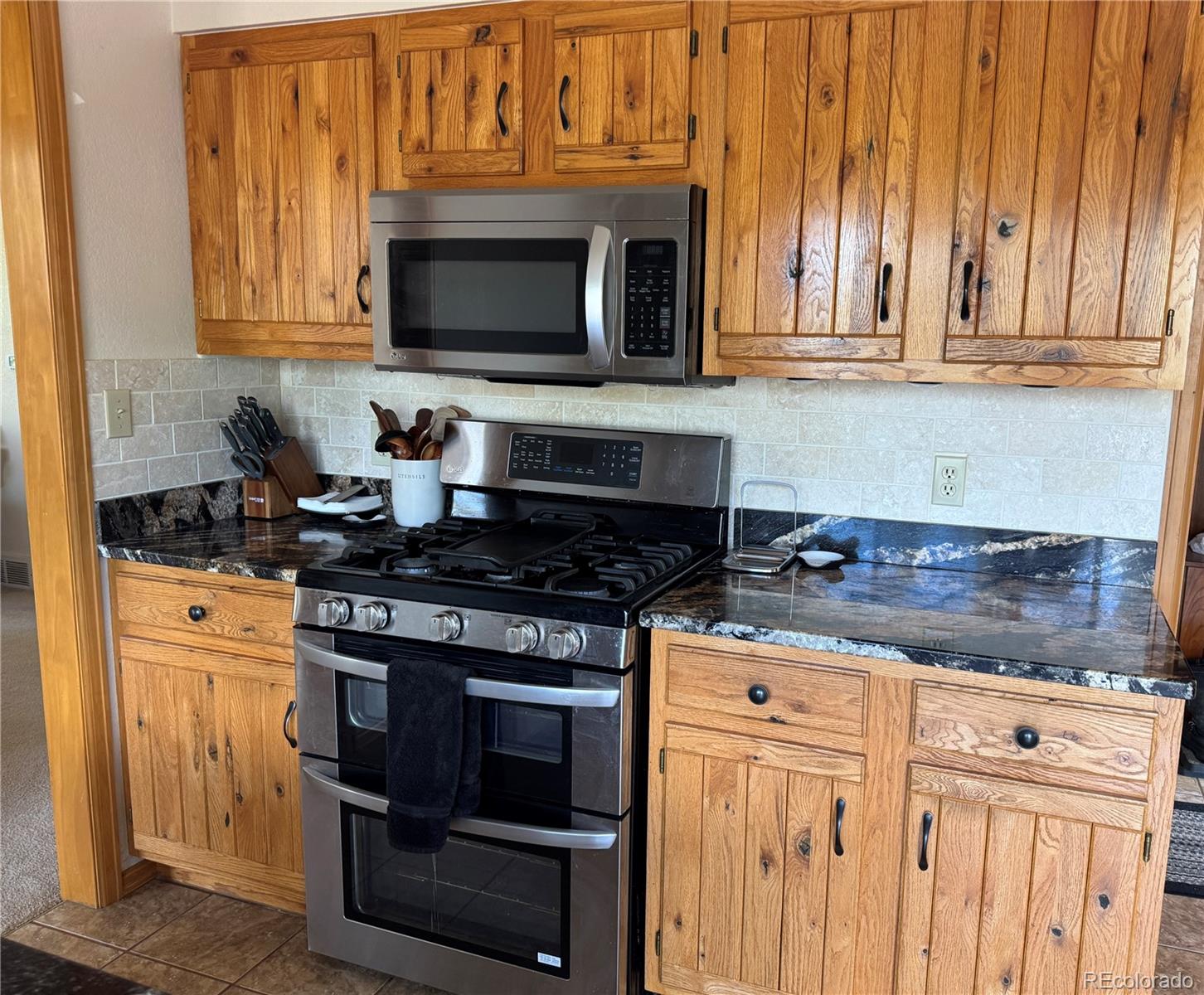 70 Highpoint Circle Black Hawk, CO 80422 - Photo 9 of 37 a kitchen with granite countertop a stove and a microwave
