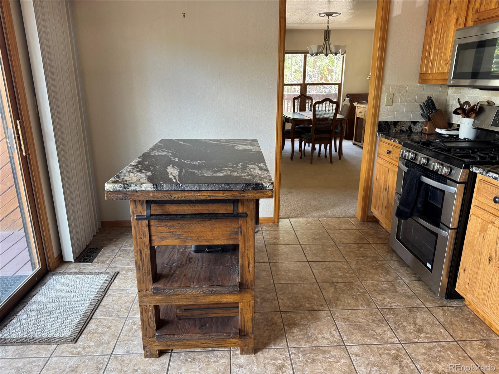 70 Highpoint Circle Black Hawk, CO 80422 - Photo 10 of 37 a kitchen with granite countertop a stove a sink and a microwave