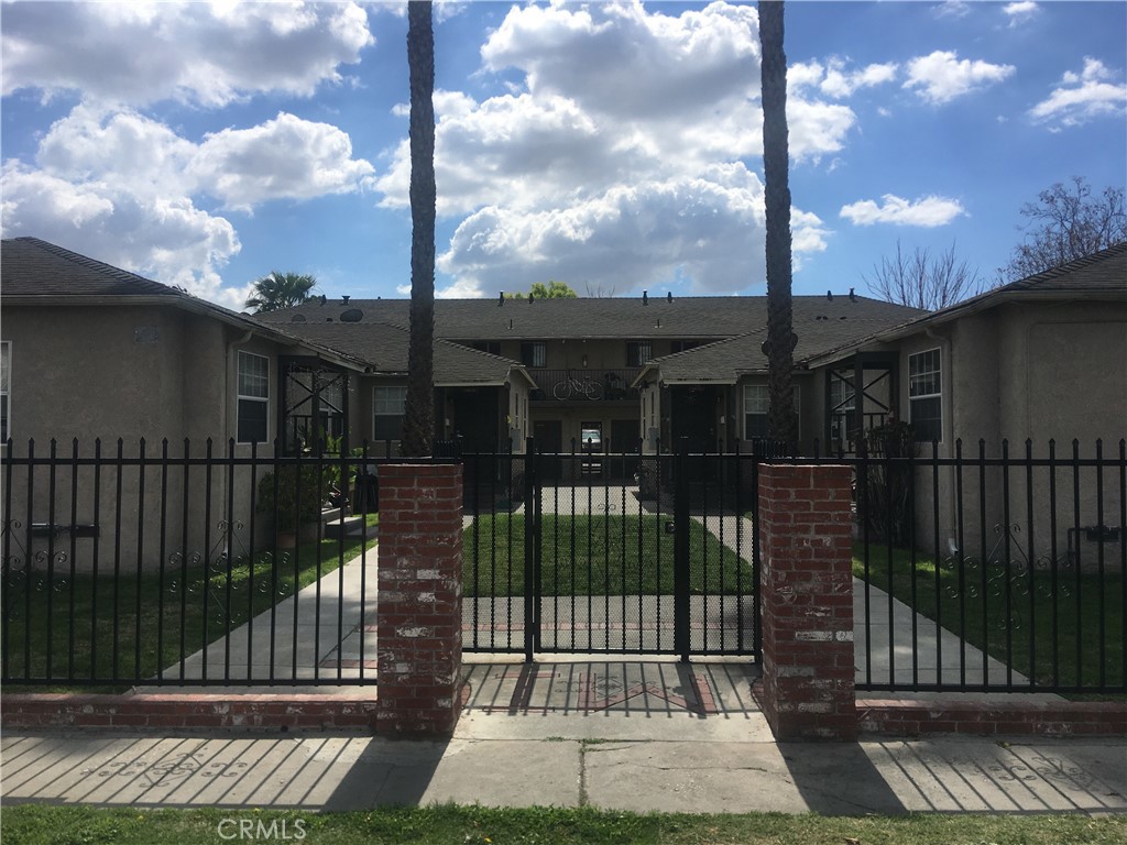a view of a brick building next to a yard